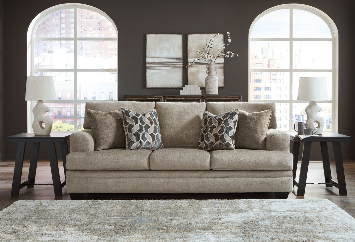 Stonemeade sofa with patterned throw pillows in light taupe and dark legs