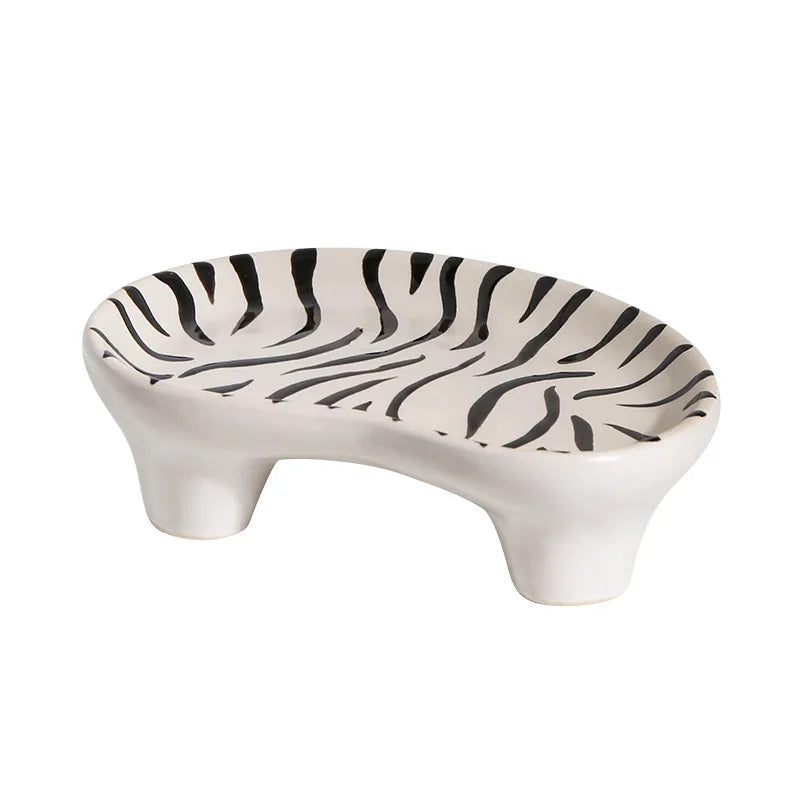 Ceramic decorative fruit plate with zebra stripe print, curved paw shape