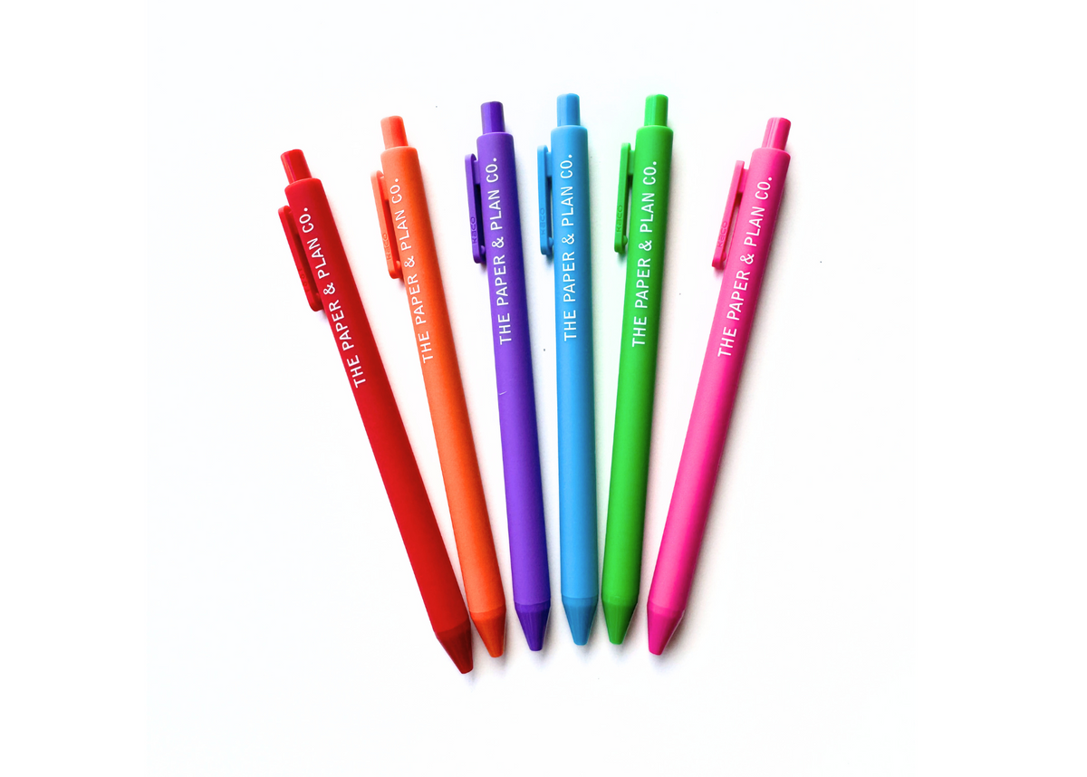 Assorted colored pens, red, orange, purple, blue, green, and pink tips aligned