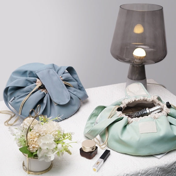 Light blue and mint green barrel drawstring makeup bags with drawstring openings