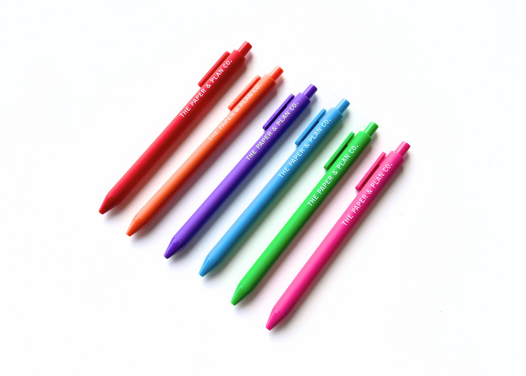 Color wheel pens shown in a fan, red through pink barrels with printed text