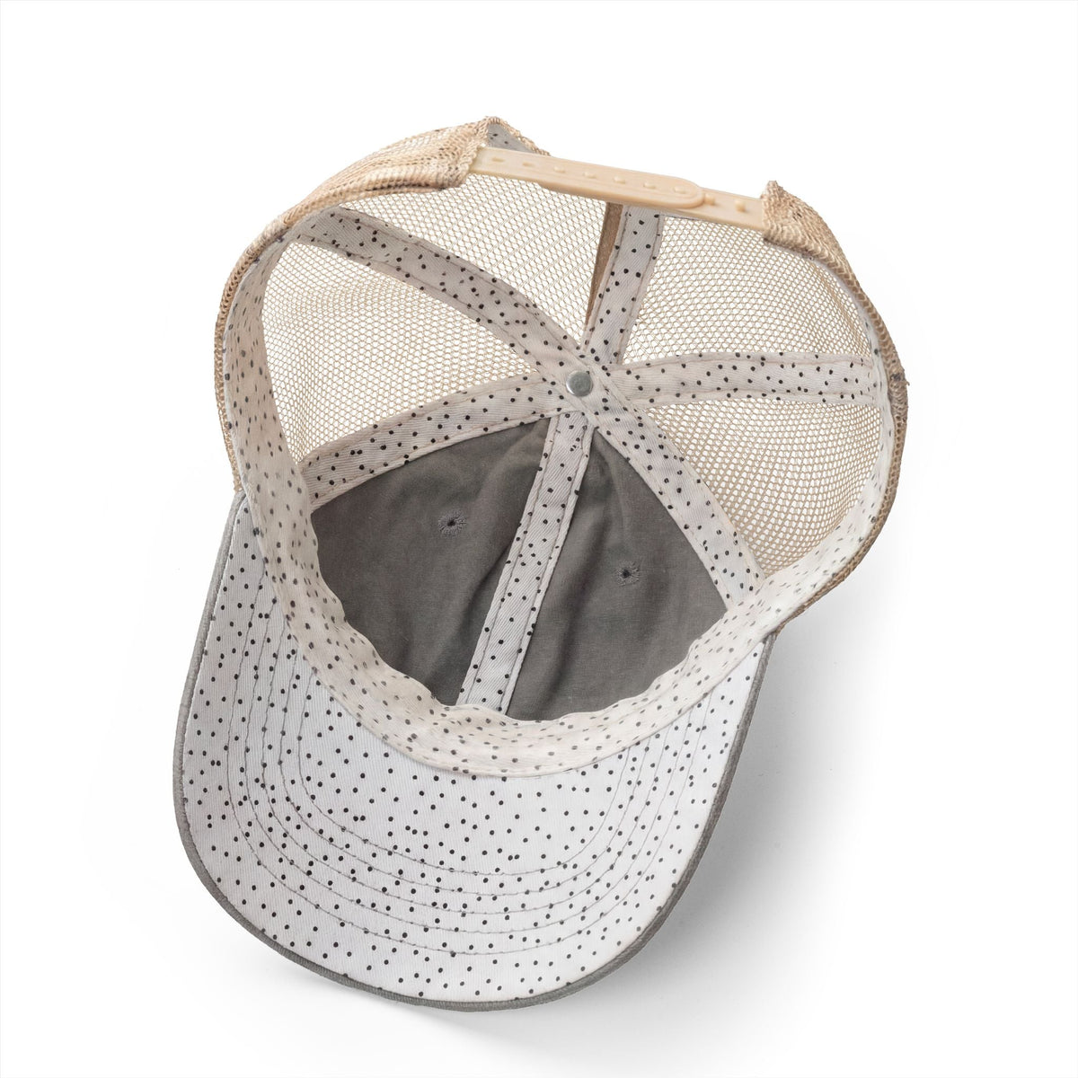 Light grey ponytail cap with polka-dot brim, mesh back, adjustable strap