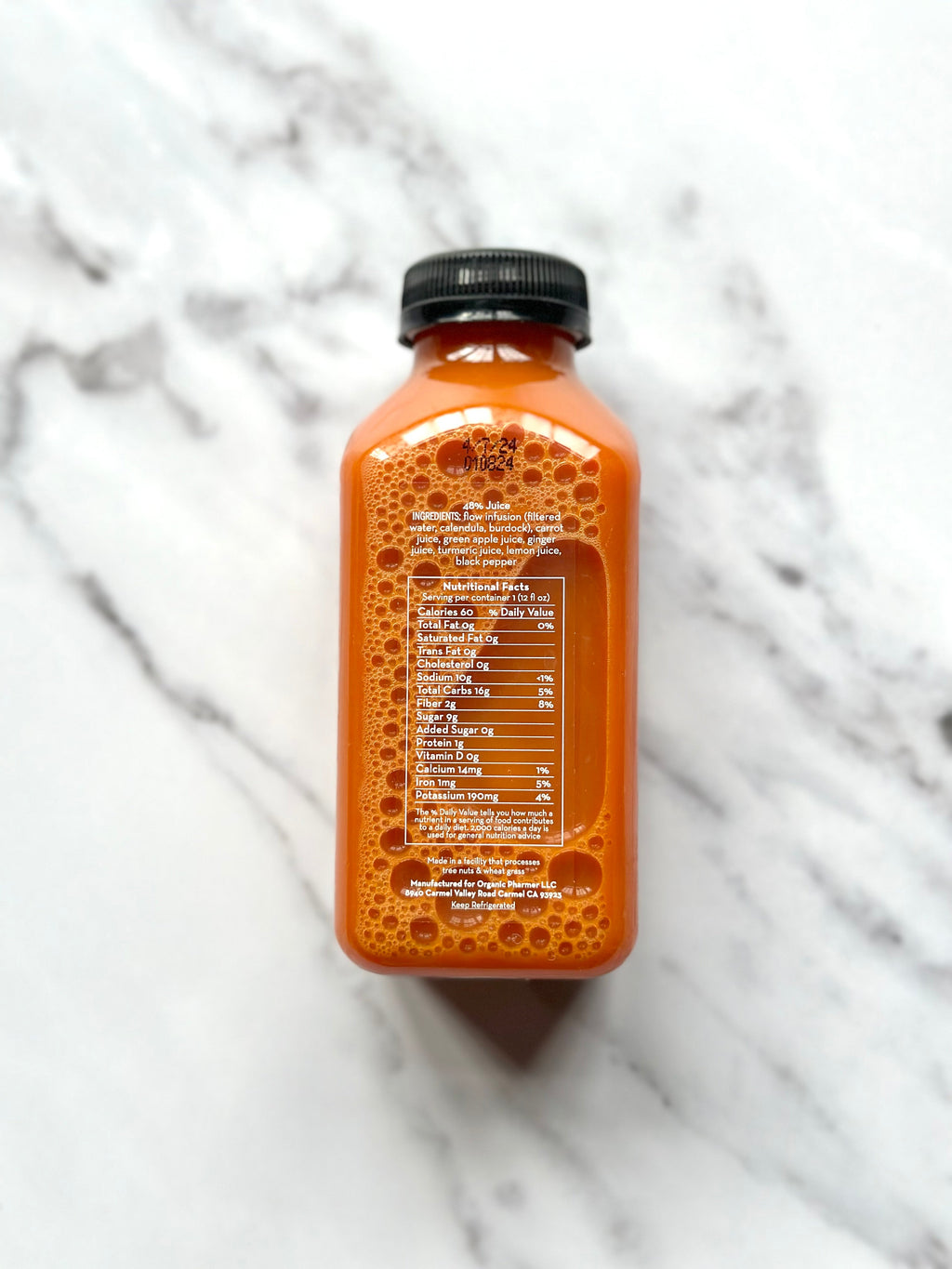 Organic Flow beverage bottle with black cap, back label text panel.