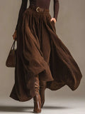 Brown turtleneck long-sleeve top with belted pleated maxi skirt, flared hem