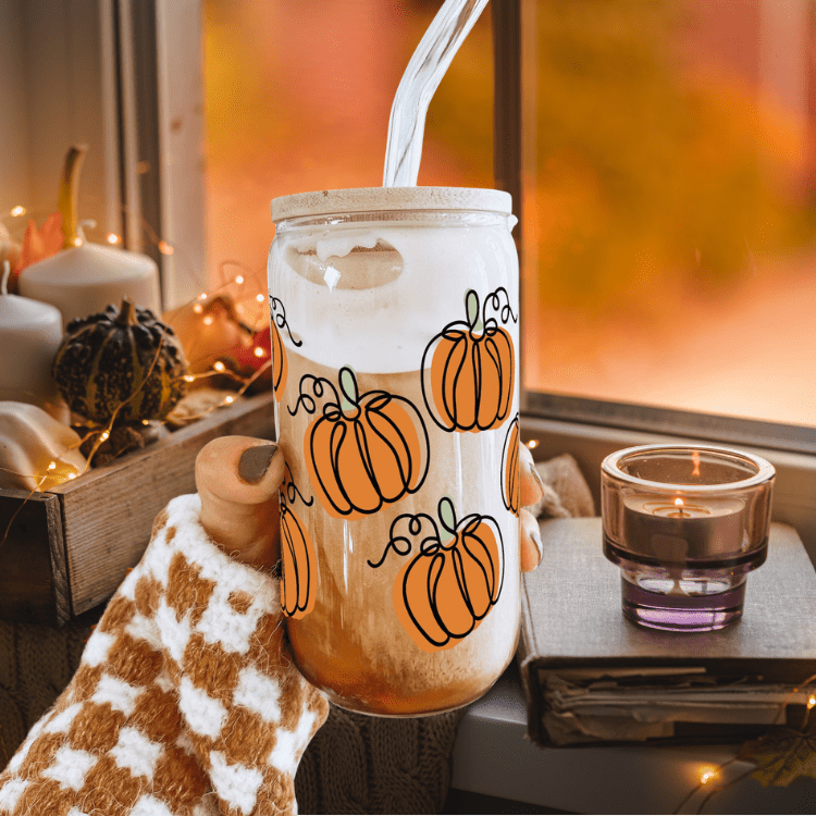 Frosted glass iced coffee tumbler with orange pumpkin print, bamboo lid and straw