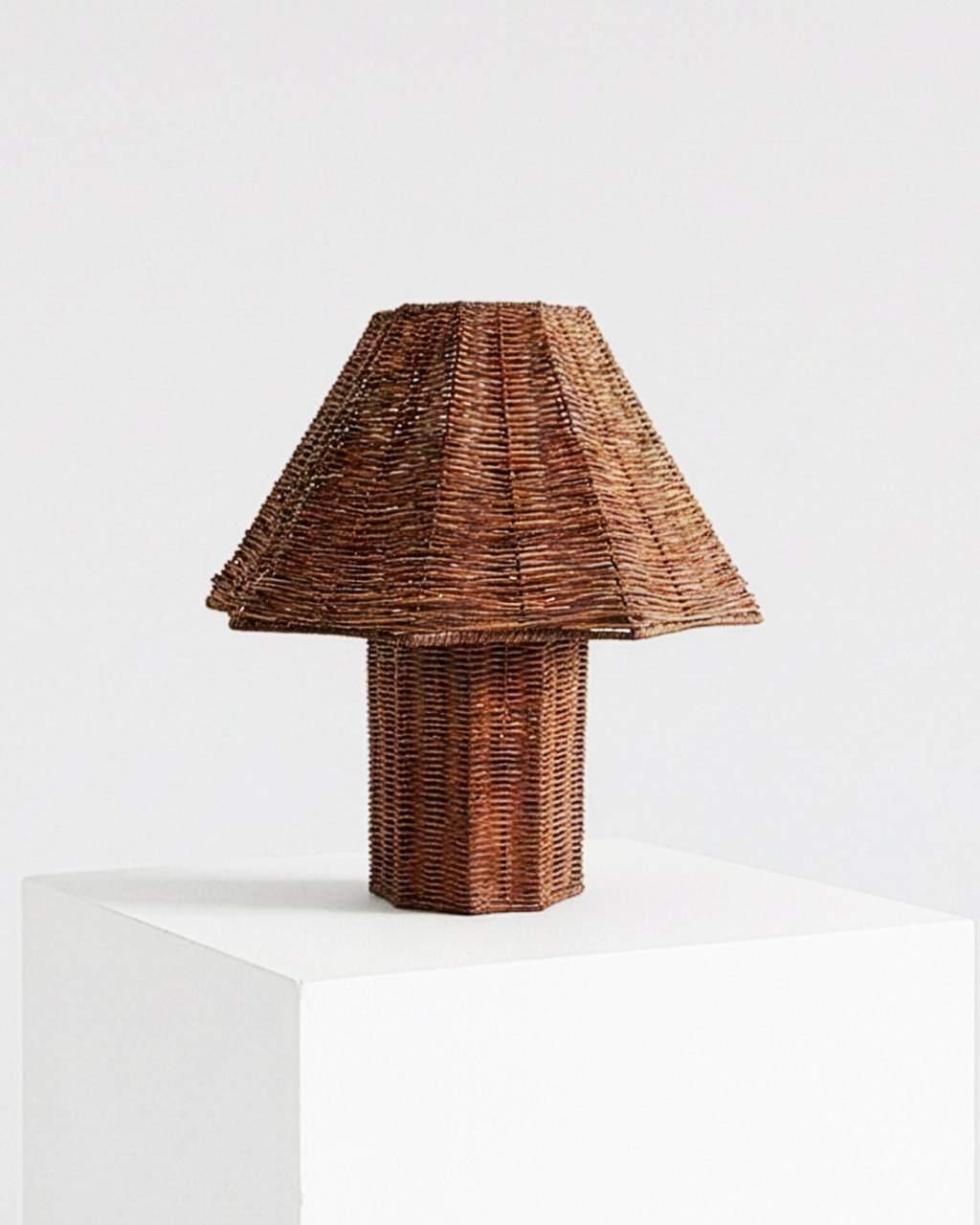 Woven rattan table lamp with conical shade and wicker cylinder base
