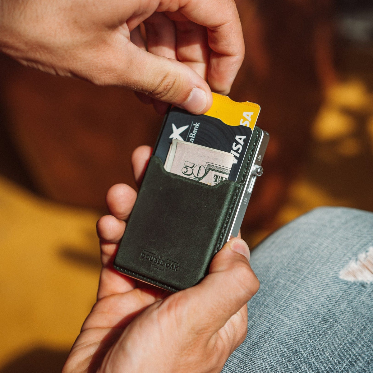 Black leather phone wallet with card slot, holding a card and cash