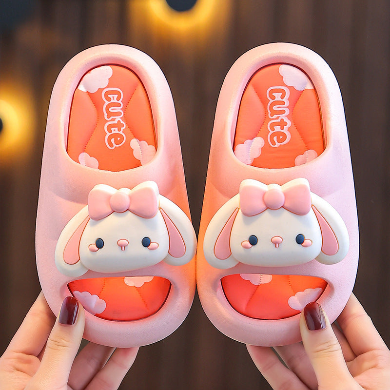 Pair of kids bunny slide slippers in light pink with bow and orange inner lining