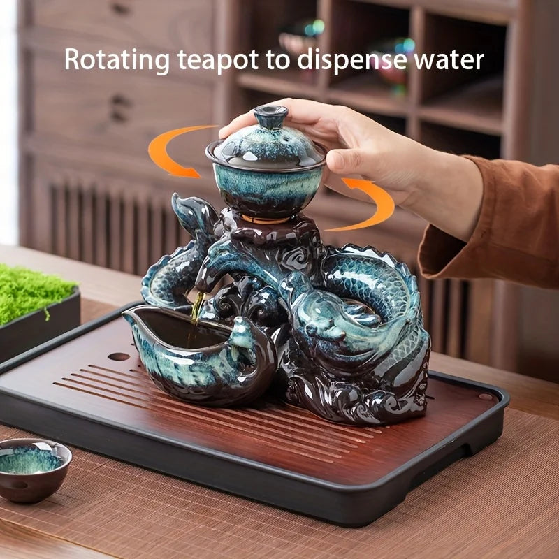 Ceramic dragon teapot set with rotating spout, teal glaze, hand holding the lid