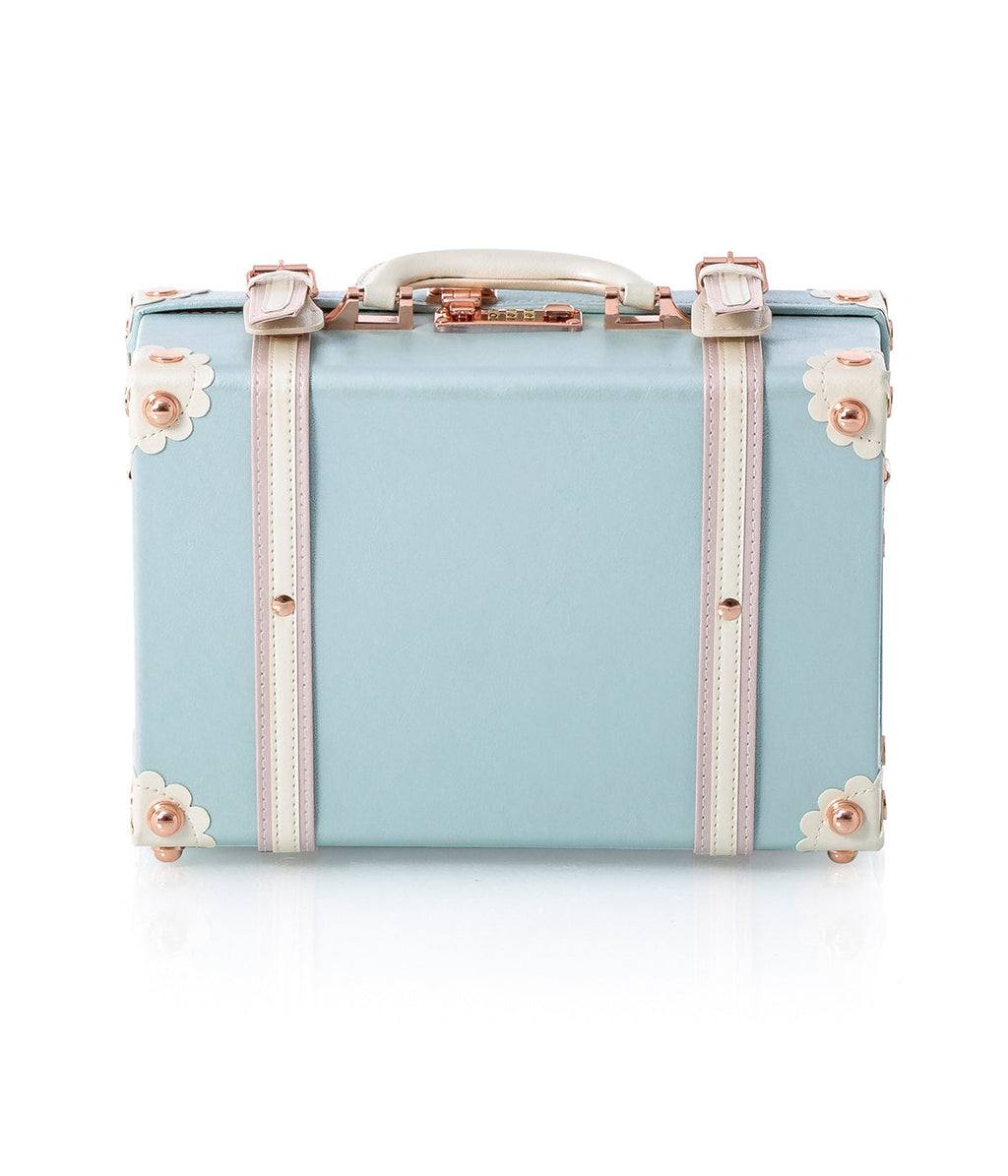 Sky-blue briefcase front with floral side panels, rose-gold buckles, and handle.