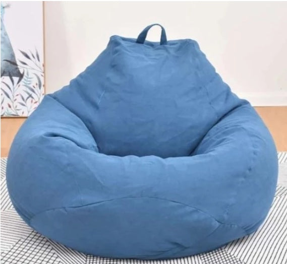 Blue oversized bean bag chair with soft fabric and top carrying handle.