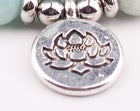 Silver-tone lotus charm on pink bead yoga bracelet with small clasp beads