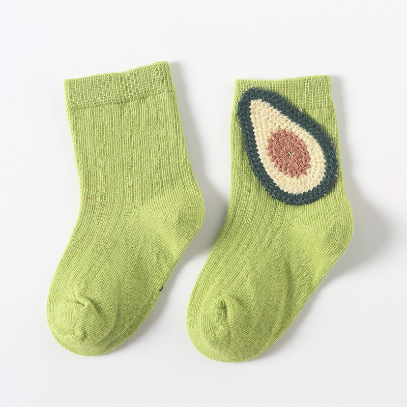 Pair of light green baby socks with avocado and dark outline applique on the instep