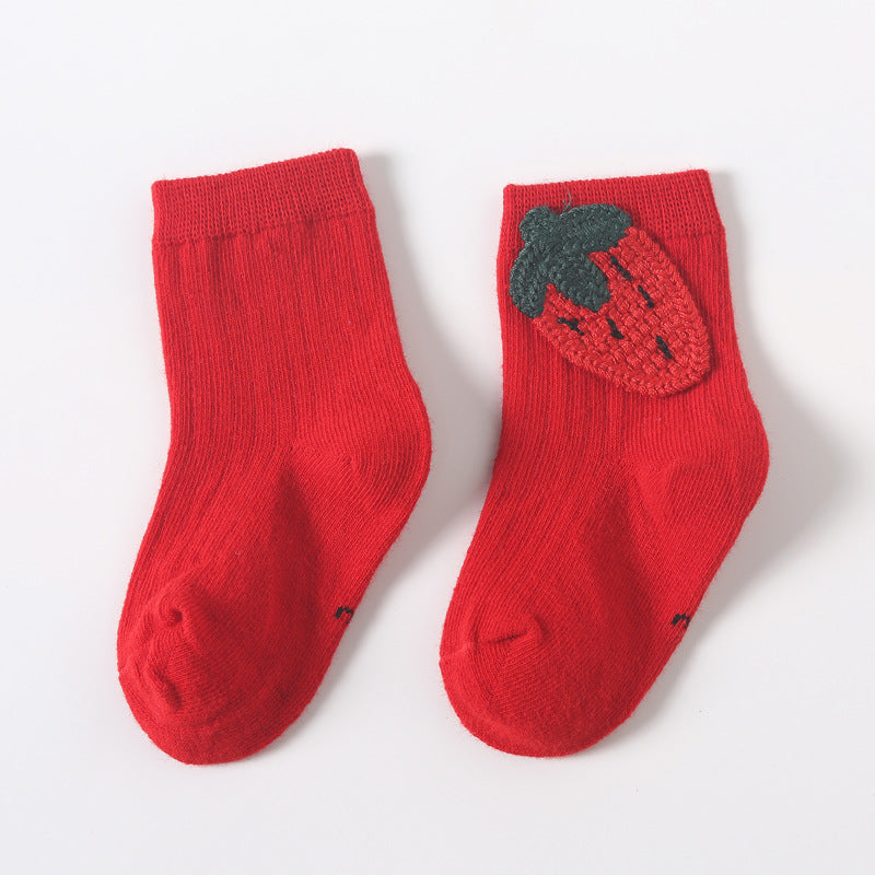 Pair of red baby socks with strawberry applique and dark leaf detail on the instep