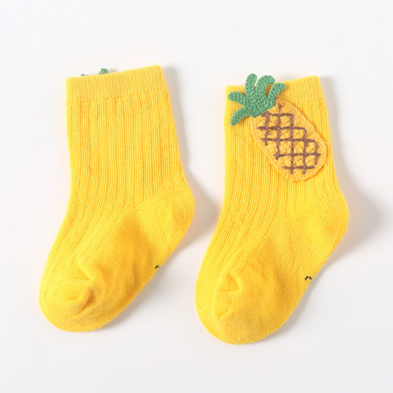 Pair of yellow baby socks with pineapple applique and green leafy top on the instep