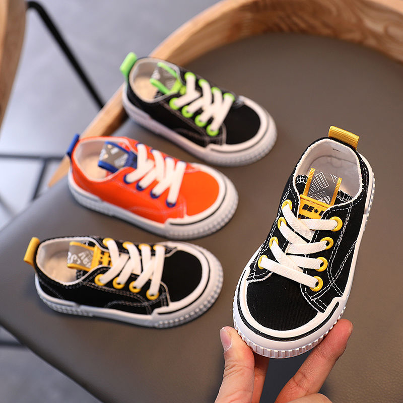 Kids canvas sneakers set: black with green laces, black with yellow laces, and orange with white laces
