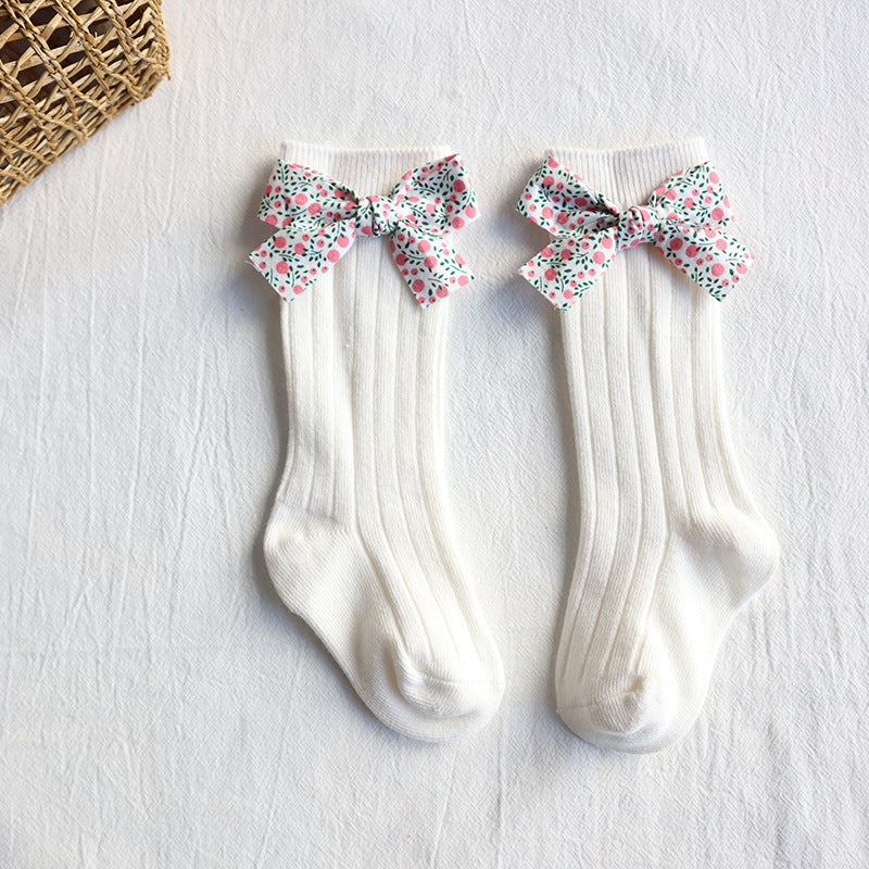 Baby long tube socks, white ribbed knit with multicolor floral bow cuffs