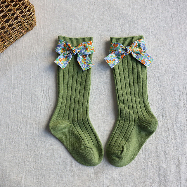 Baby long tube socks, green ribbed knit with multicolor floral bow cuffs