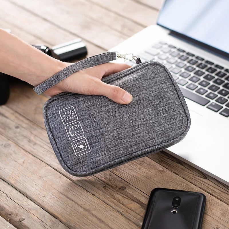 Gray cable organizer bag with wrist strap and clear device icon patch on front.
