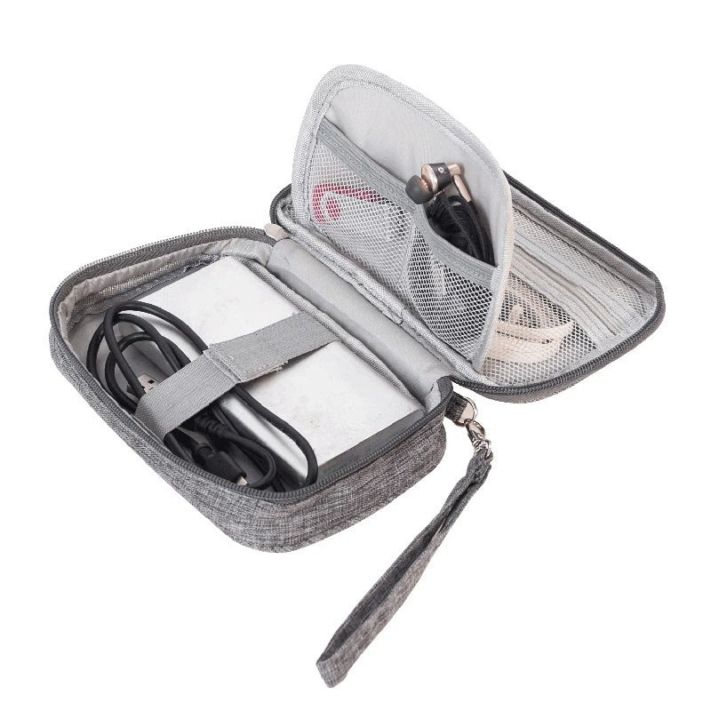 Light gray cable organizer bag open showing elastic bands and a mesh pocket divider.