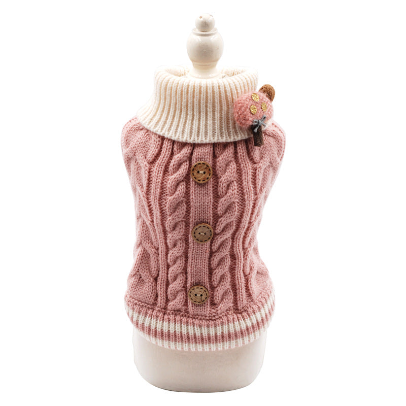 Pink cable-knit pet sweater with white turtleneck, brown button details, bear patch