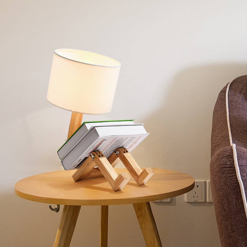 Wooden bedside desk lamp with white fabric shade on round wooden tabletop base