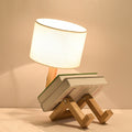 Wooden bedside desk lamp with white fabric shade and angled wooden brace