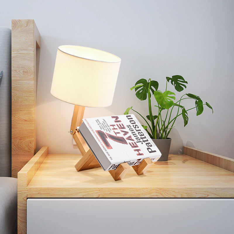 Wooden bedside desk lamp with white fabric shade on wooden pivot stand
