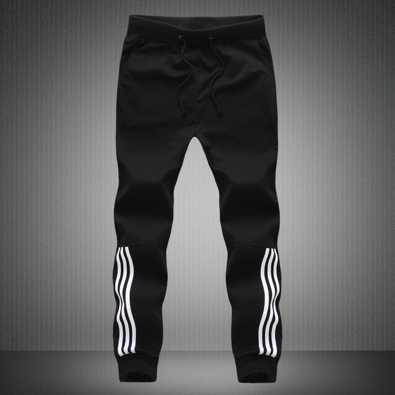 Men's black jogger-style pants with drawstring and white triple stripe cuffs