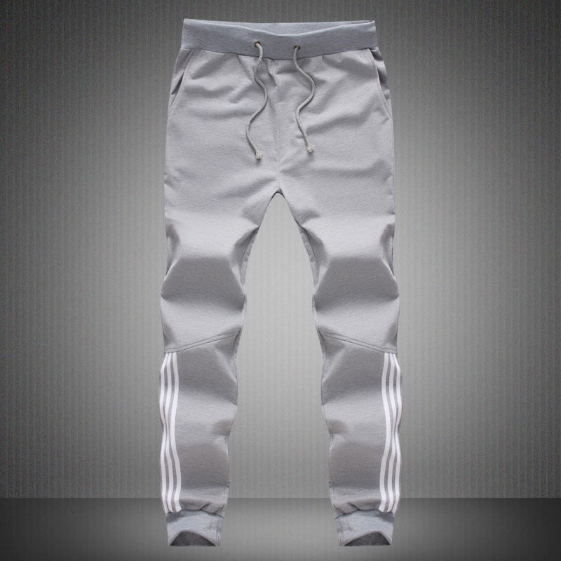 Men's light grey jogger-style pants with drawstring and white triple stripe cuffs