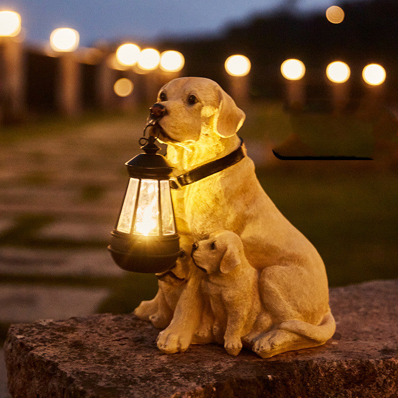 Resin dog lantern sculpture: tan dog sitting with cubs, holding a lit glass lantern