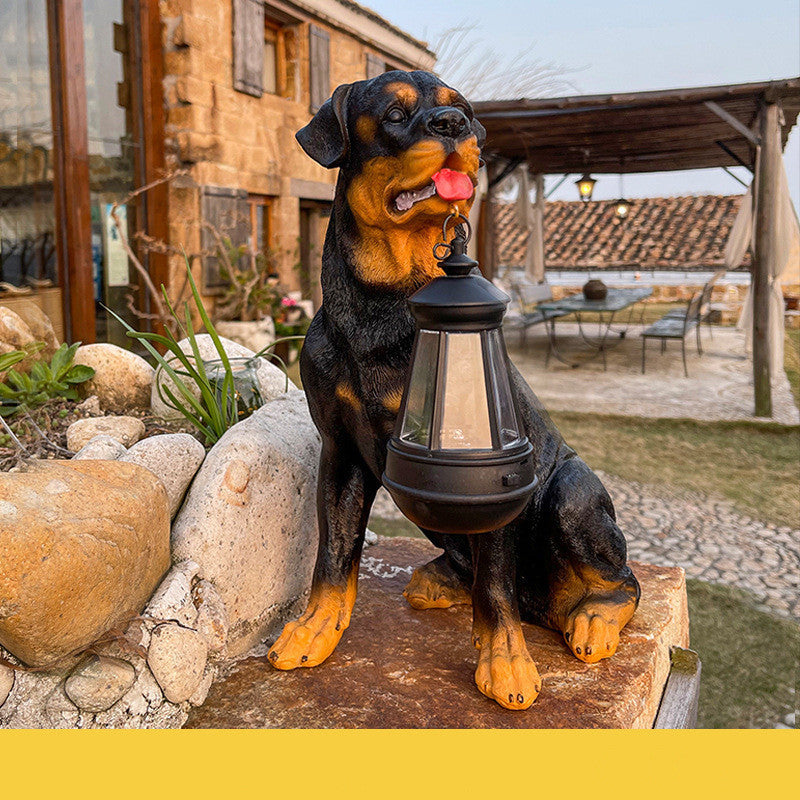Solar LED dog lantern sculpture: black-and-tan dog statue holding a glowing lantern.