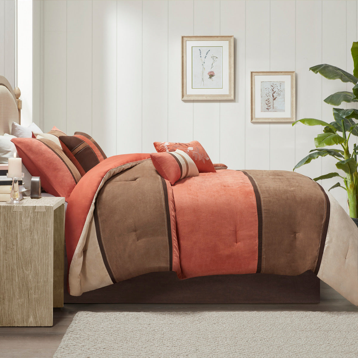 Queen comforter set on bed with coral, brown, and cream striped pillows and shams