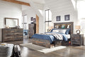 Dark wood storage bed with bookcase headboard and lower drawers, blue bedding