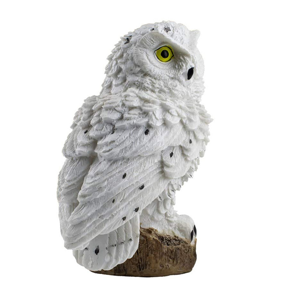 Outdoor solar owl garden light with white owl figure on rock base