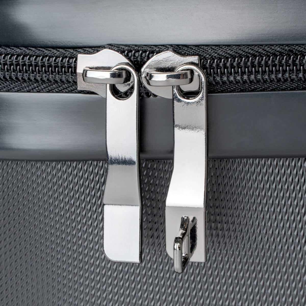 Hard-shell suitcase zipper pull with shiny metal clasps and track