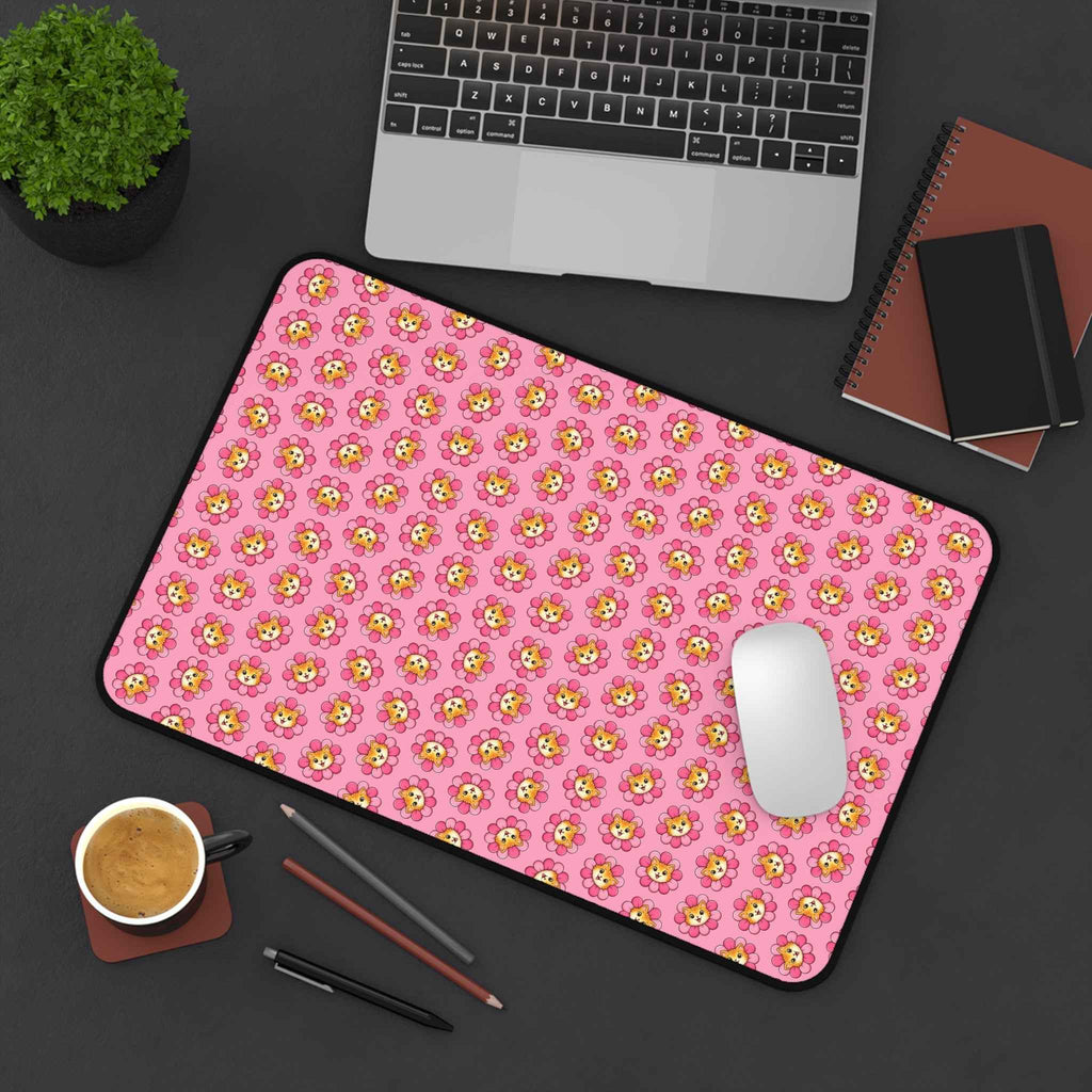 Pink cat-pattern desk mat with black edge trim and mouse cutout