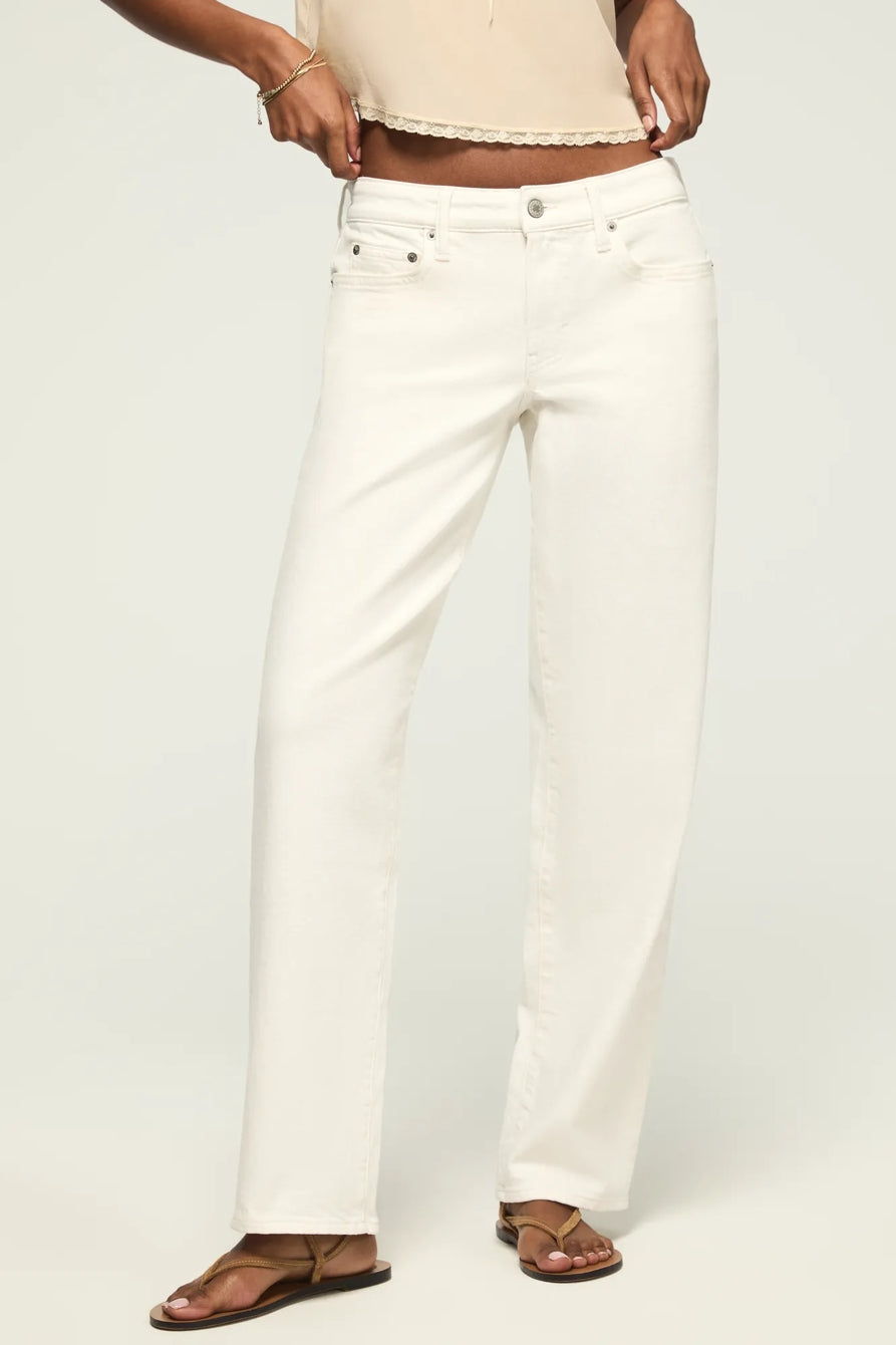 Women's baggy white jeans with button closure and relaxed straight-leg fit