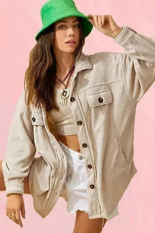 Light beige oversized fleece jacket with button front and chest flap pockets