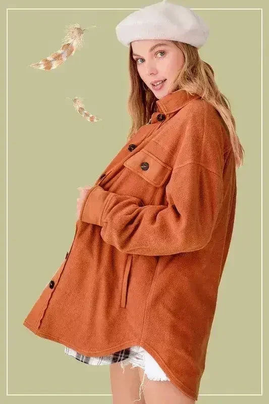 Rust orange oversized fleece jacket with button front and chest flap pockets