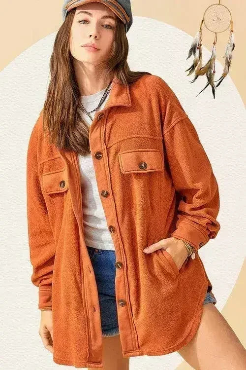 Rust orange oversized fleece jacket with button front and chest flap pockets