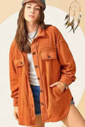 Rust orange oversized fleece jacket with button front and chest flap pockets