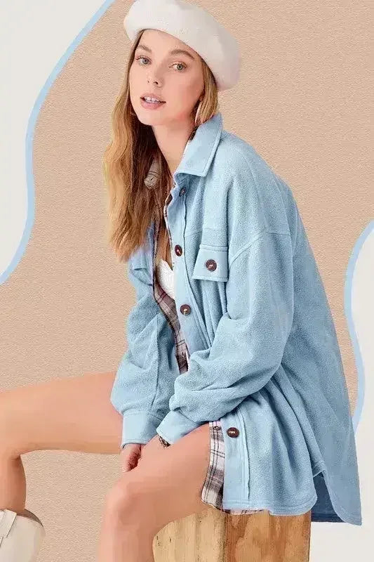 Light blue oversized fleece jacket with button front and chest flap pockets