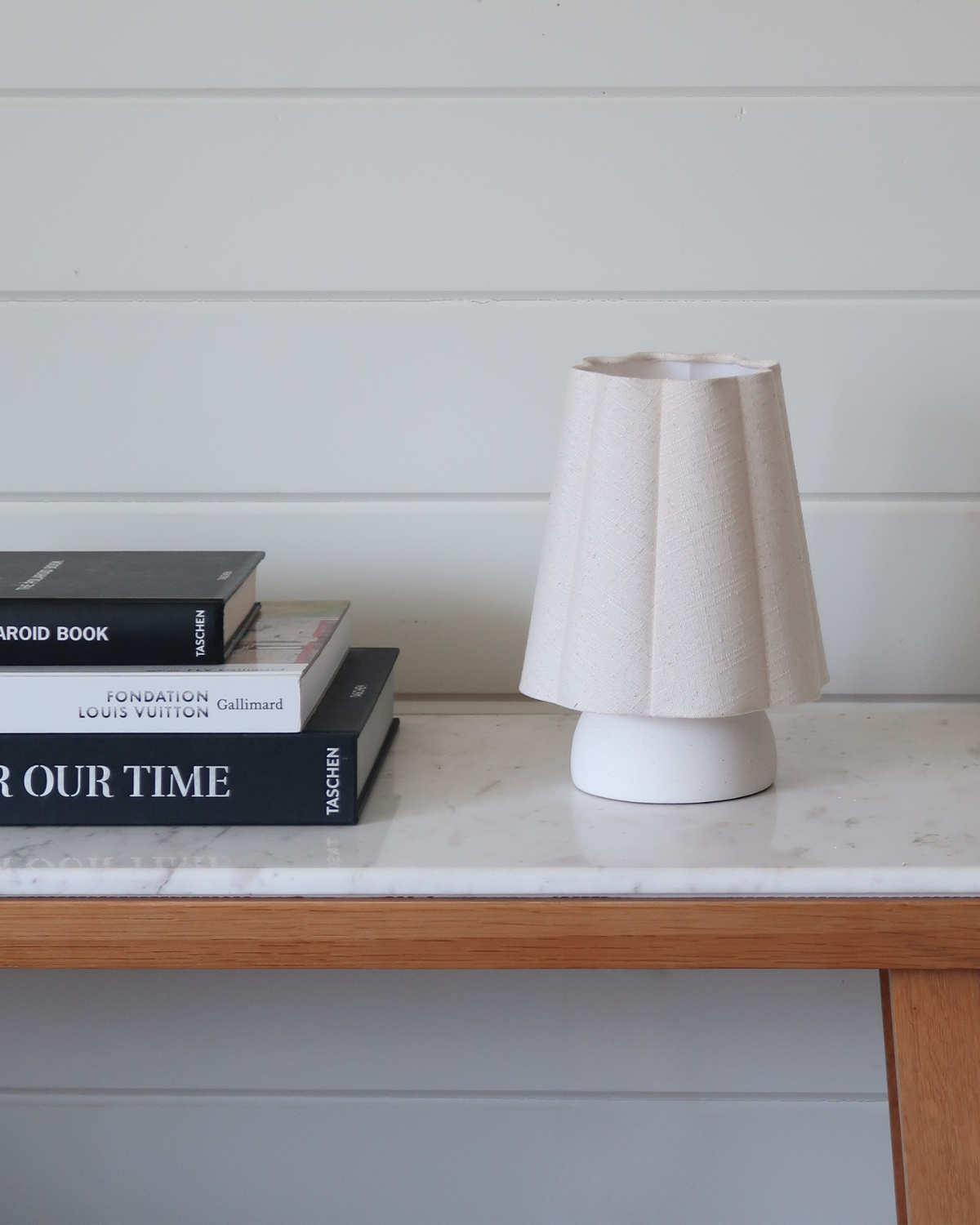 Table lamp with white fabric drum shade on white rounded base