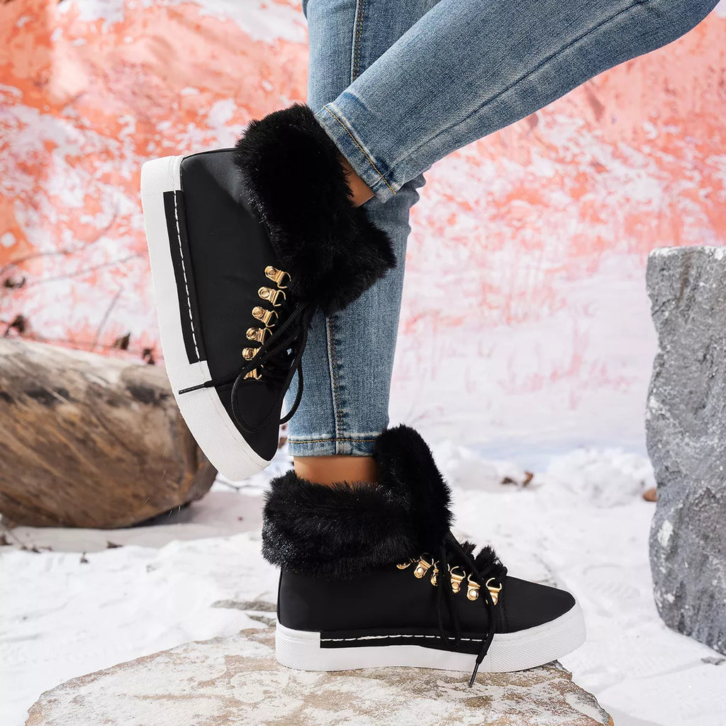 Black lace-up ankle boots with faux-fur collar and gold hardware on white sole