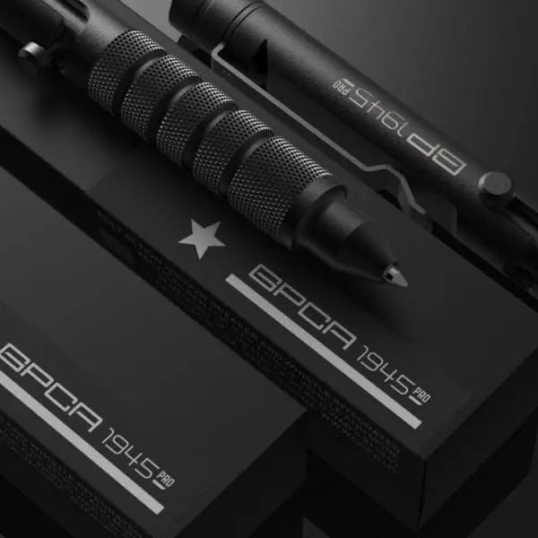 Close-up of dark bolt-action EDC pen with knurled grip and star logo