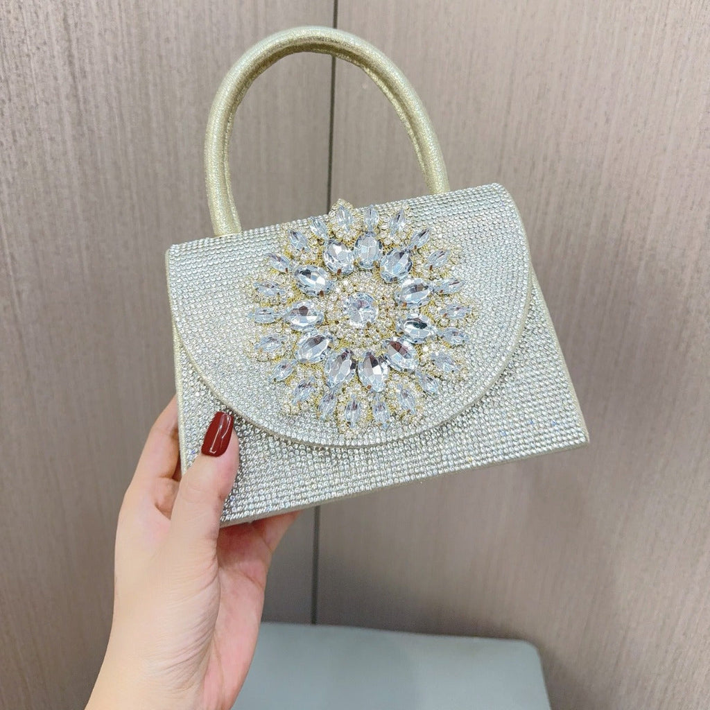 Gold beaded clutch purse with large jeweled floral centerpiece on front flap