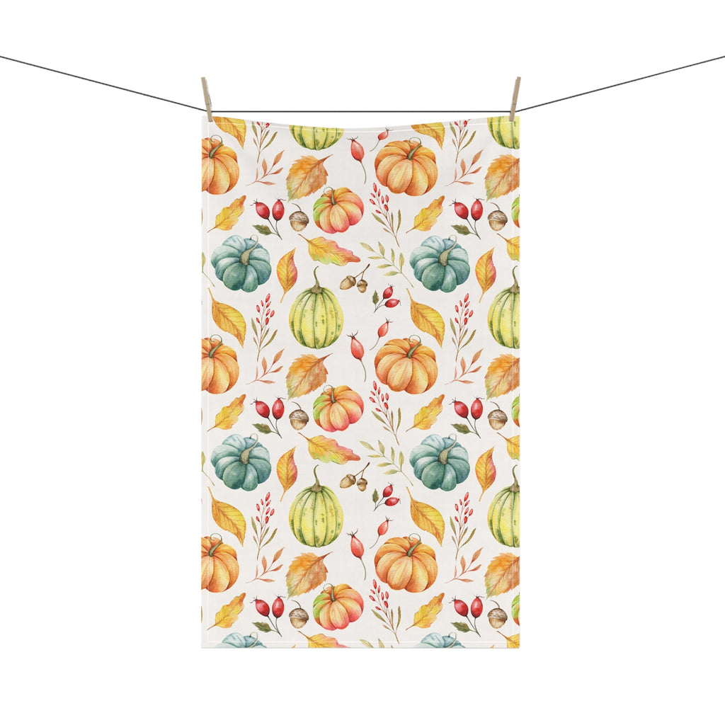 Cream autumn harvest tea towel with pumpkin and gourd print, clipped to a line.