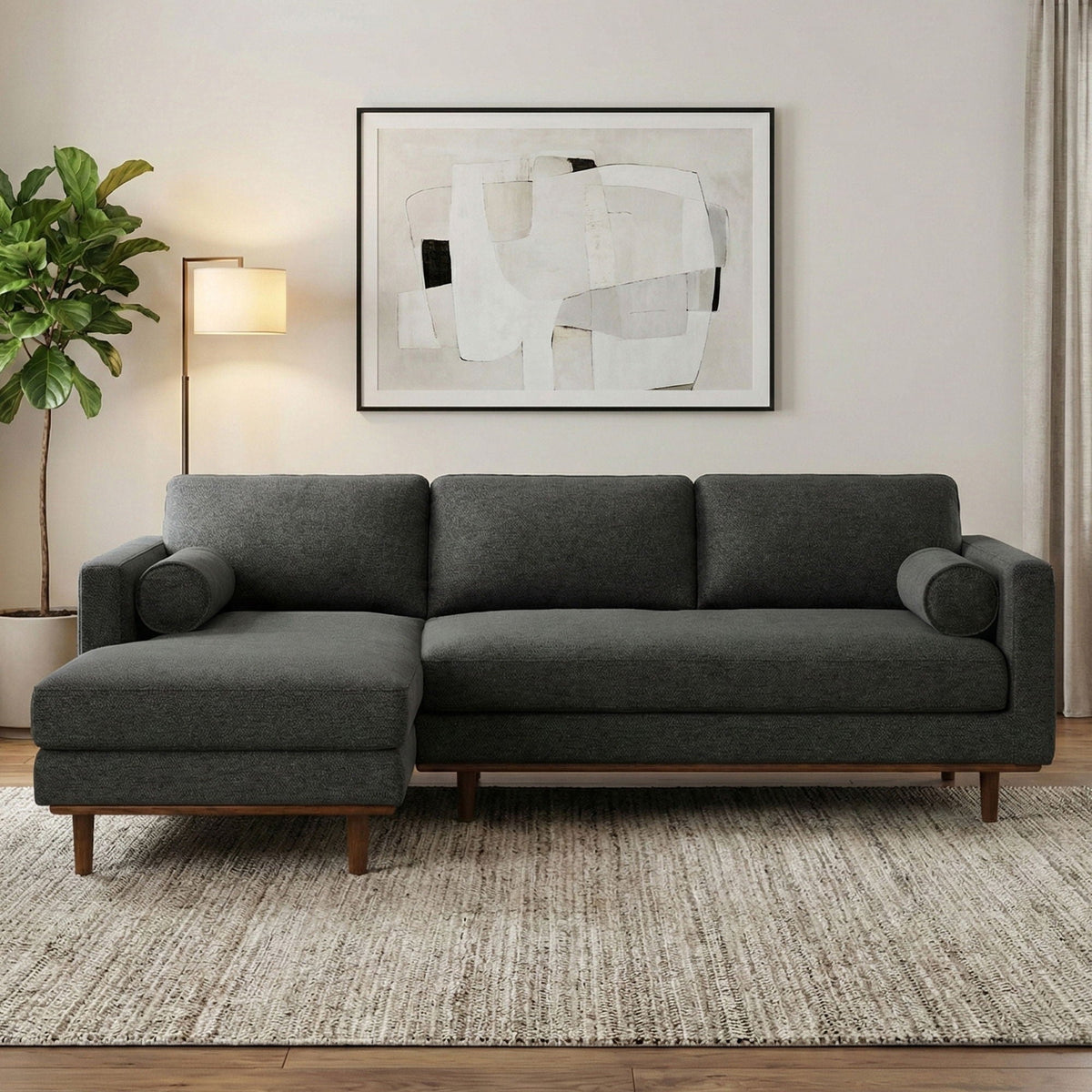 Upholstered sectional sofa in dark gray fabric with chaise extension and square arms