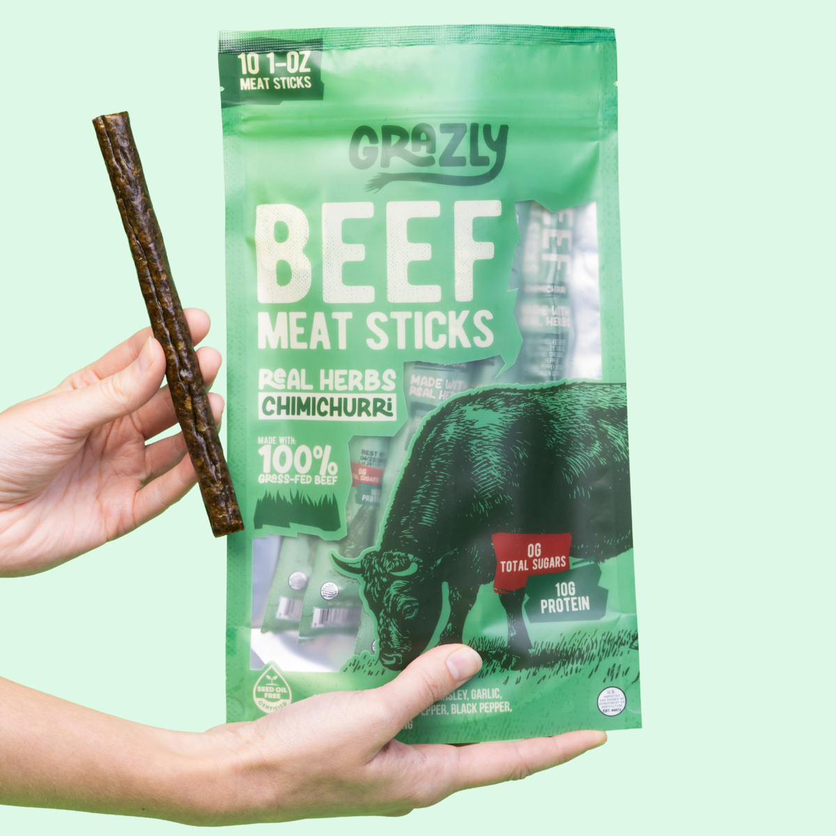 Chimichurri beef meat sticks pouch with a beef stick held by a hand
